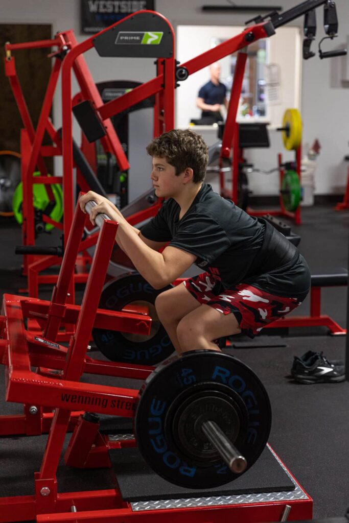 athlete training lower-body strength at The Rack
